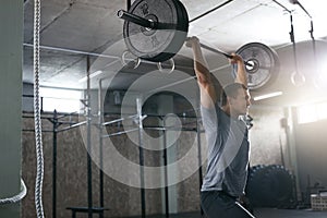 Sports Man Lifting Barbell Row At Workout Gym