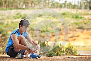 Sports, man and shoes on a floor by runner start fitness, running and cardio exercise in a forest, calm and ready