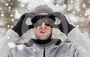 Sports man with ski goggles in winter outdoors