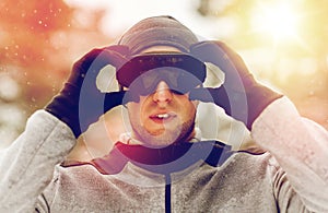 Sports man with ski goggles in winter outdoors