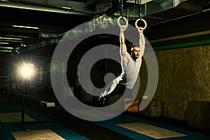 Sports Man Training With Gymnastics Rings At Gym