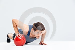 Sports man working out with fitness ball