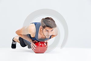 Sports man working out with fitness ball