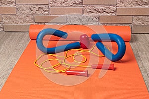 Sports mat and sports equipment - jump rope and expander  healthy lifestyle concept