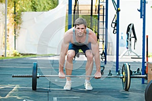 Sports model exercising outside as part of healthy dumbbells