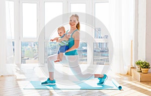 Sports mother is engaged in fitness and yoga with baby at home