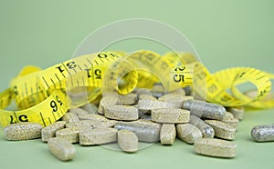 Sports nutrition (supplements). Natural vitamins and supplements on a green background. Healthy lifestyle concept.