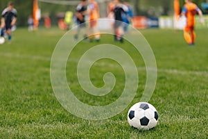 Sports outdoor background. Soccer ball on the field. Football competition tournament match in the blurred background