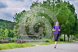 Sports outdoor - young woman running in park