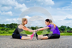 Sports outdoor - young women doing fitness in park