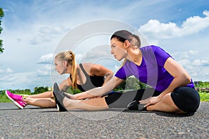 Sports outdoor - young women doing fitness in park