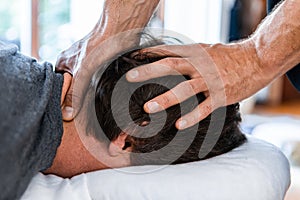 Sports physiotherapist massaging muscular strong man