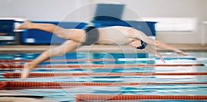 Sports, pool and male athlete diving for training, exercise or competition for indoor swimming. Fitness, action and