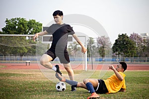 Sports and recreation concept two male soccer players attending regular practice sessions and memorizing attack and defense