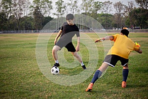 Sports and recreation concept two male soccer players attending regular practice sessions and memorizing attack and defense
