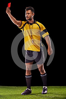 Sports, referee or man with a red card for warning, foul call or penalty review in football game on turf. Soccer match