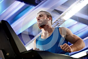 Sports, runner and man running on treadmill in gym for health, speed or challenge for marathon. Fitness, exercise and