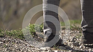 Sports shoe closeup, exercise outdoors. Male walking outside. Fitness and health concept. Closeup tourist man legs