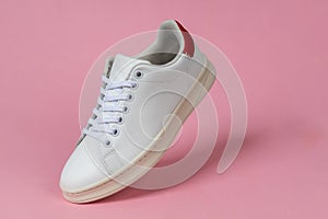 Sports shoe on pink background. Sneaker or trainer. White shoe. fitness, sport, training concept