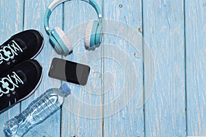 Sports shoes, water bottle on blue background concept of healthy living, healthy eating, sports and diet