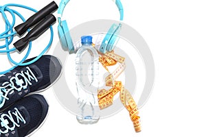 Sports shoes, water bottle, music headphones, healthy lifestyle concept, healthy food, sports and diet