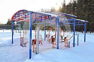 Sports simulators under light roof, outdoor in winter, park sports area near forest border