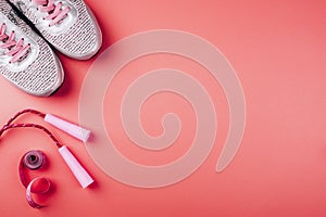 Sports sneakers, jump rope and bright pink centimeter close-up