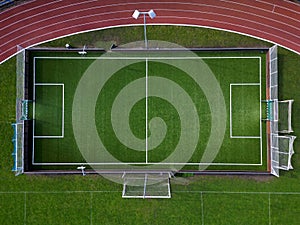 sports stadium with a running track with several lanes. inside the oval there is