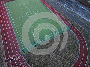 sports stadium with a running track with several lanes. inside oval there is a