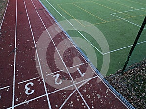 sports stadium with a running track with several lanes. inside oval there is a