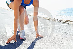 Sports, start and woman running by beach for race, competition or marathon training exercise. Fitness, health and