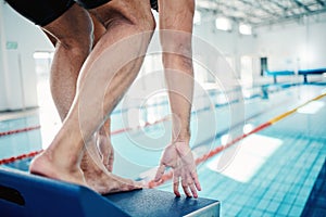 Sports, swimming and man on diving board by pool for training, exercise and workout in competition. Fitness, motivation