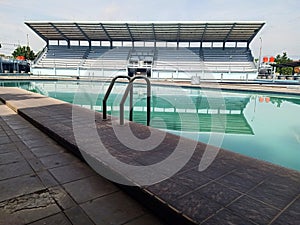sports swimming pool with spectator stands in the background