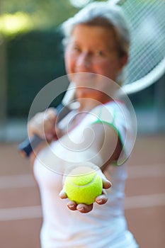 Sports, tennis ball and woman athlete on a court for exercise, workout or training for competition. Fitness, equipment
