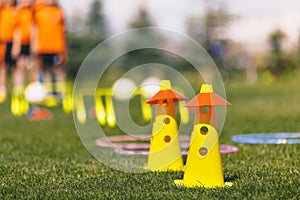 Sports training tools. Soccer equipment on pitch. Yellow and red practice cones on sports field