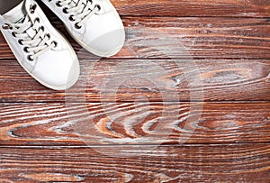 Sports white sneakers on wooden background. Fitness concept. Concept healthy lifestyle. Top view. Copy space