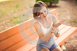 Sports woman with arm pain outdoor. Healthcare and medicine concept