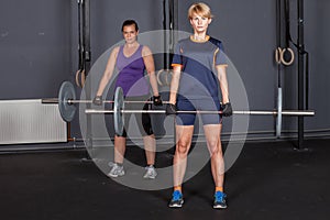 Sports woman barbell training weight lifting