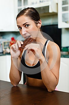 Sports woman with chocolate.