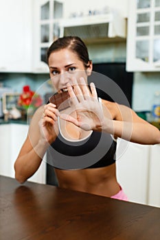 Sports woman with chocolate.