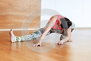 Sports woman doing stretching in the hall before yoga photo