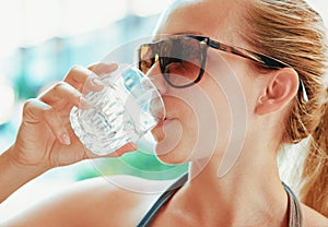 Sports woman drink water in the summer, hot