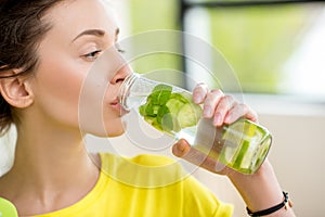 Sports woman drinking water