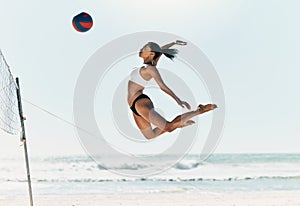 Sports woman jump at volleyball beach summer outdoor competition game on ocean or sea sand playing to win. Healthy