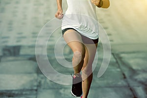 Sports woman running upstairs on stone stairs