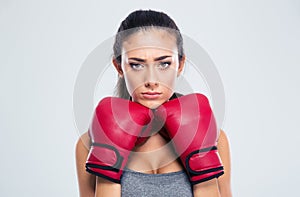 Sports woman standing in defence stance with boxing gloves