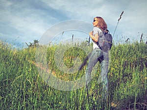 Sports woman traveler hiking with backpack on the steppe meadows. Travel Lifestyle concept adventure summer vacations outdoor
