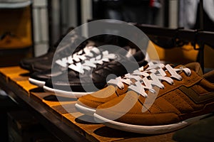 Sports youth light shoes. Sneakers made of genuine leather on the shelf of a shoe store.