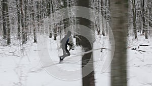 Sportsman in activewear running at winter forest