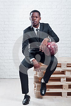 Sportsman with a ball wearing business suit